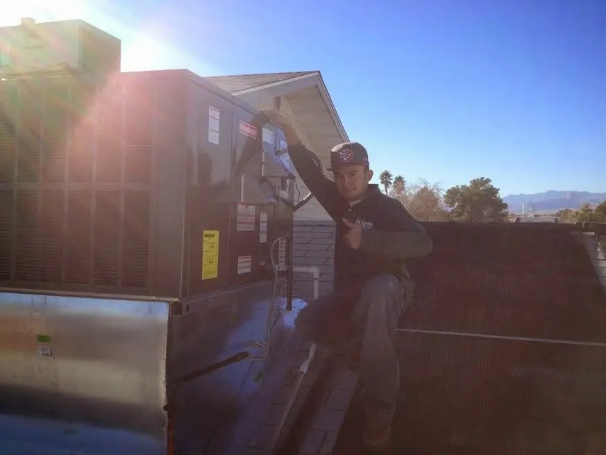 HVAC technician performing AC Tune-Up on a rooftop unit in Gresham Park